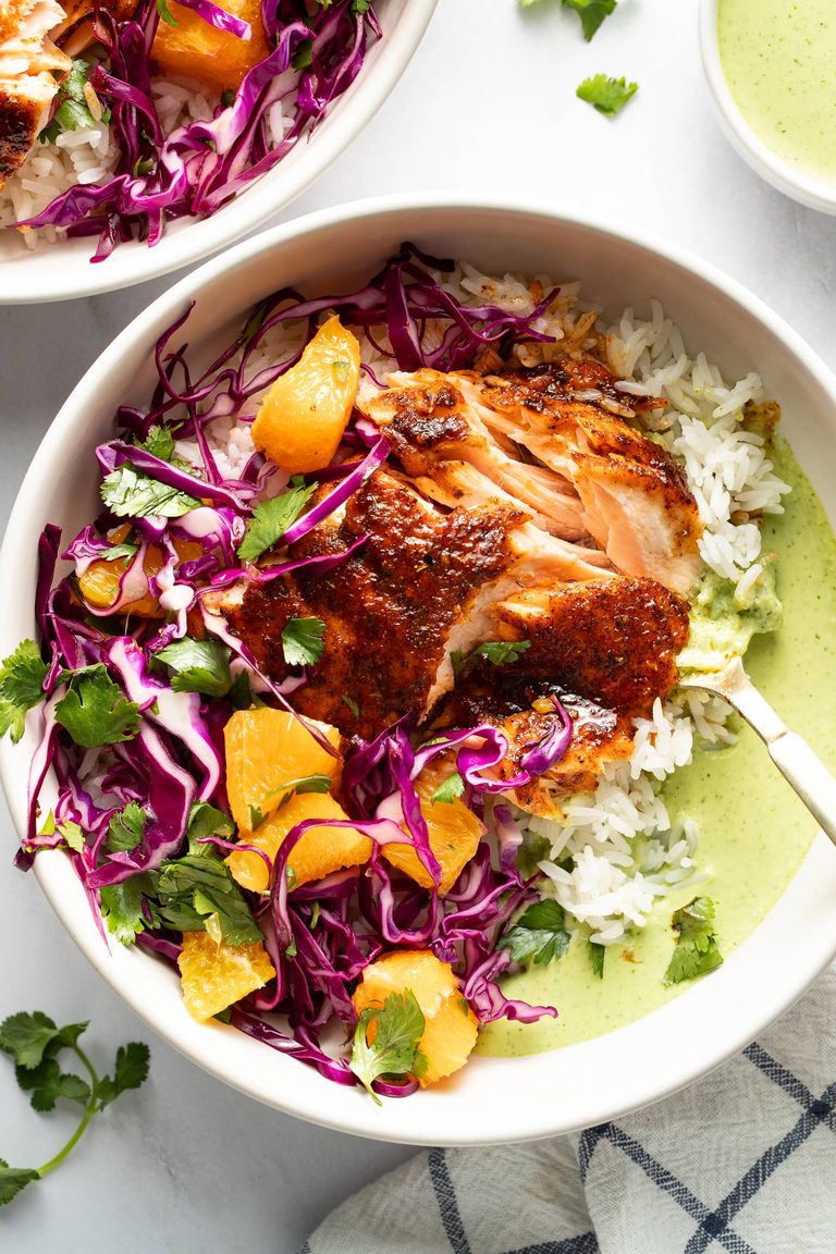 Chipotle salmon in a bowl with rice and aji verde.