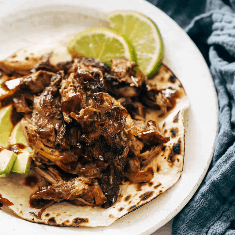 Crockpot carnitas on a tortilla.