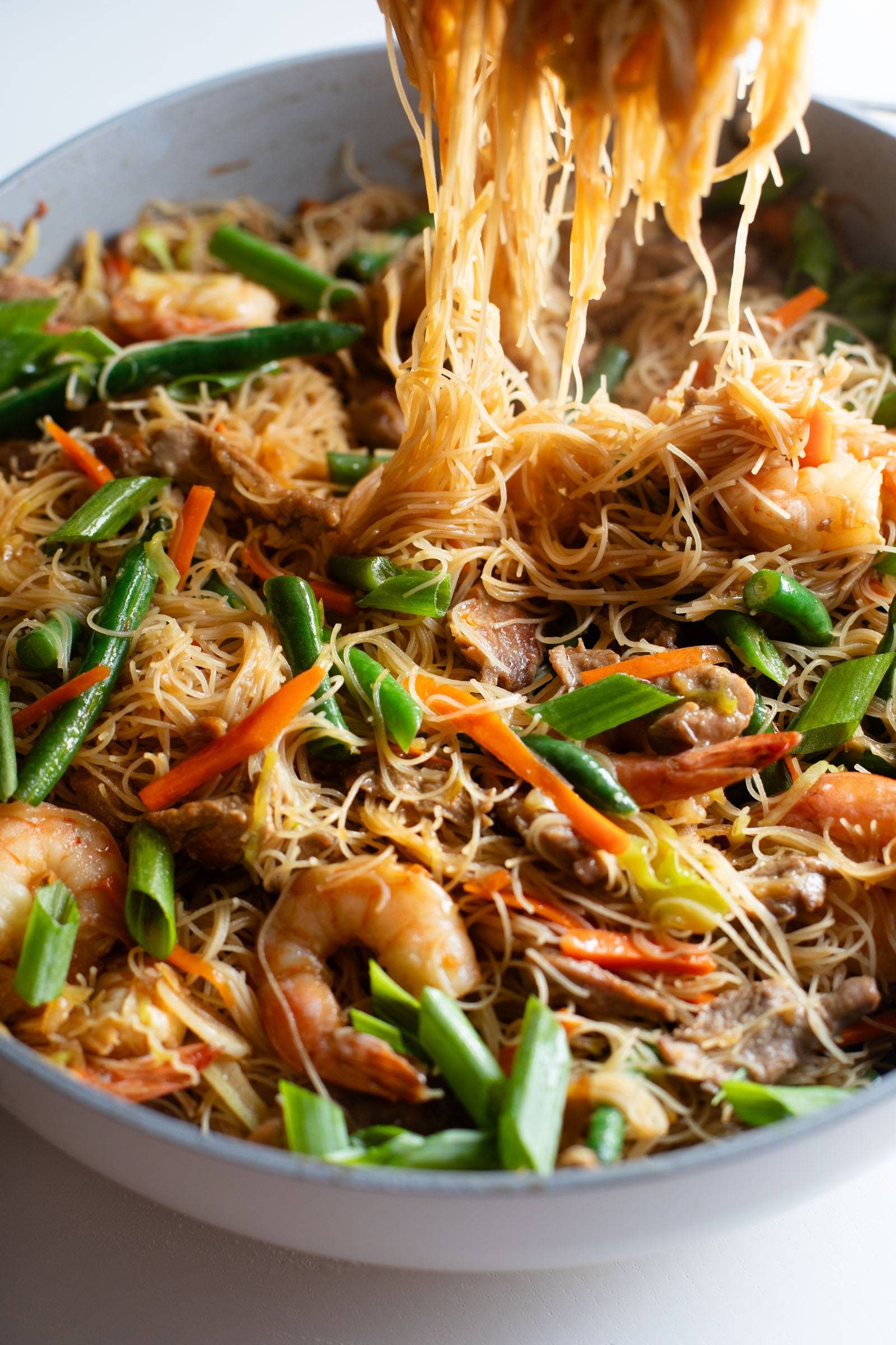 Pancit in a skillet.