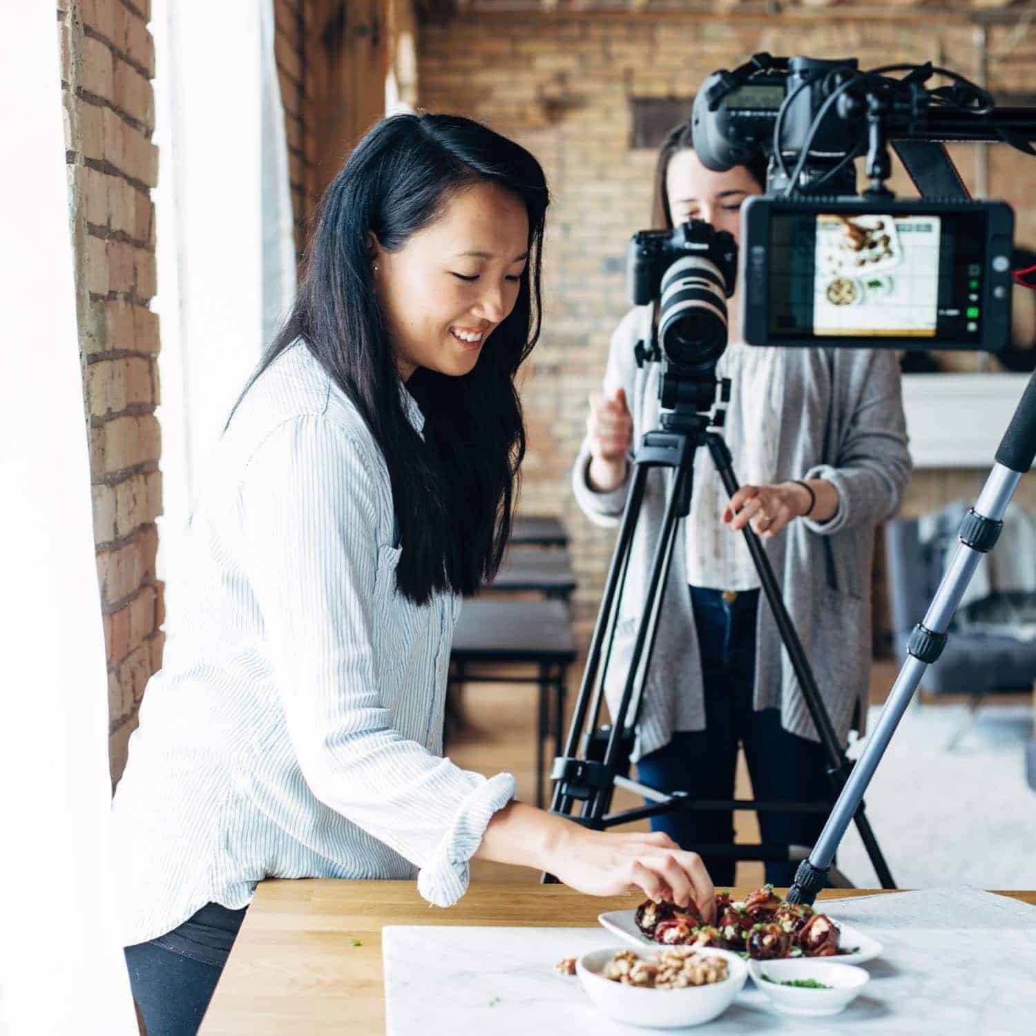 Woman styling food for a recipe video.