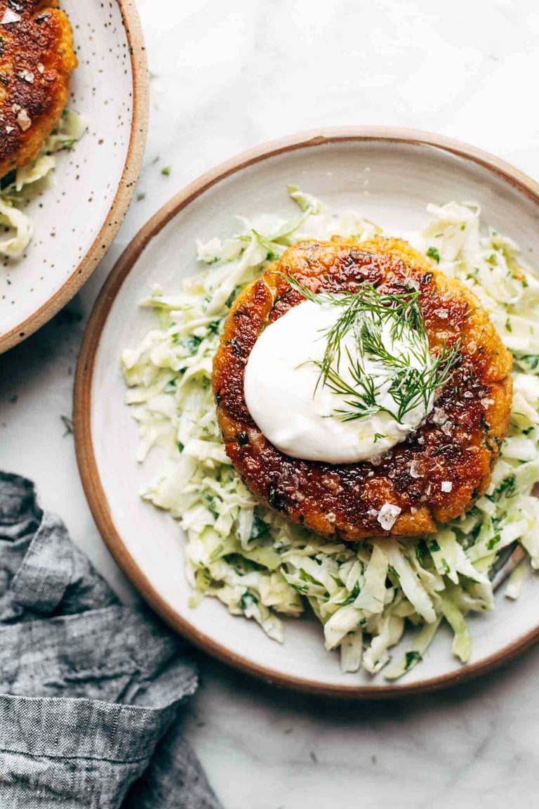 Salmon burgers over slaw.