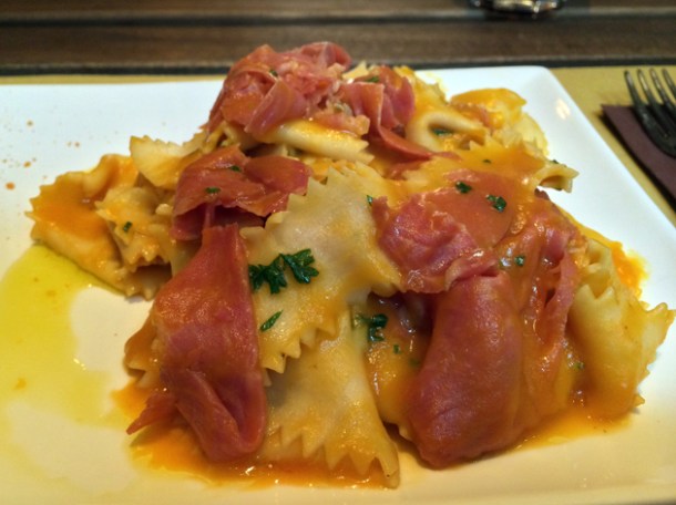 spinach egg pasta with pork shoulder and rosemary in pumpkin sauce at in parma