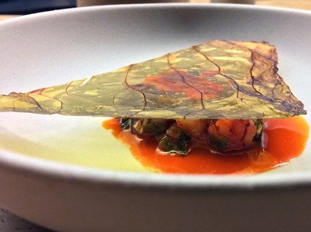 chopped red prawn and cabbage underneath dried shiso leaf at mãos