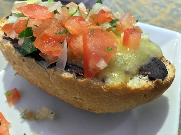illustrative photo of the mollettes topped bread at La Chingada